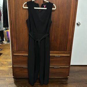 Vince Camuto black white leg jumpsuit with belt at waist.